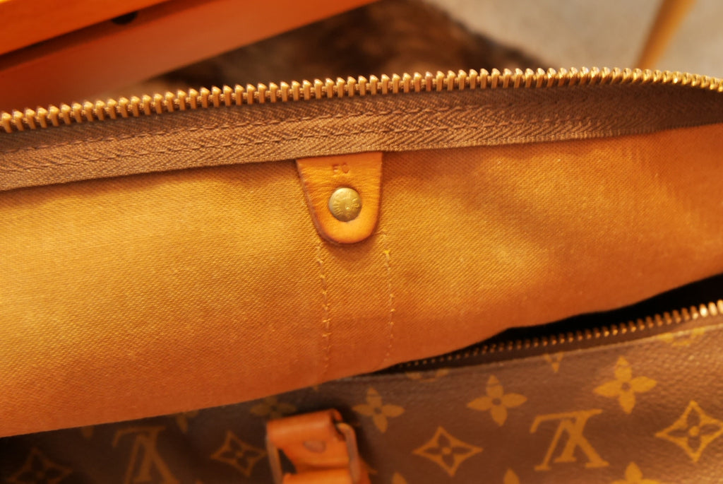 Lot - A Louis Vuitton leather and monogram canvas Sac Marin duffle, late  20th century